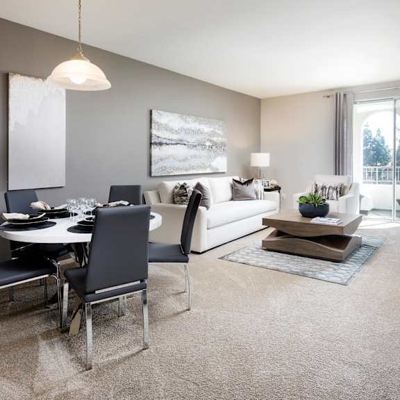 a modern living room with a dining table and chairs. at la jolla crossroads apartments, california, 92122
