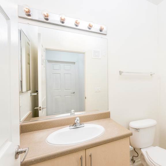a bathroom with a sink, toilet, and shower. at la jolla crossroads apartments, san diego