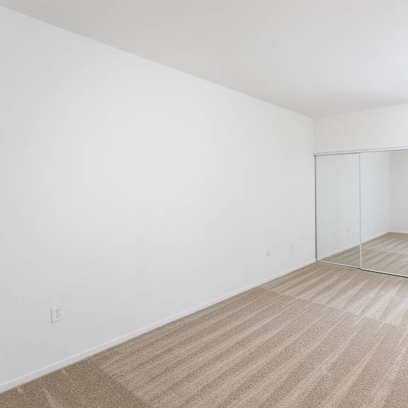 a room with a carpeted floor and a sliding door. at la jolla crossroads apartments, san diego, ca