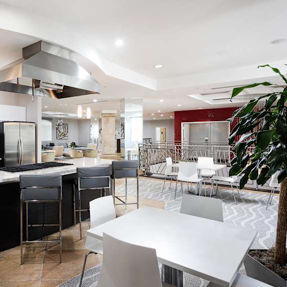 a modern kitchen with black and white appliances and furniture. at la jolla crossroads apartments, california, 92122
