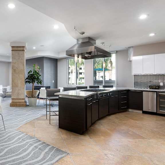 a modern kitchen and dining area with a large island and chairs. at la jolla crossroads apartments, san diego, 92122