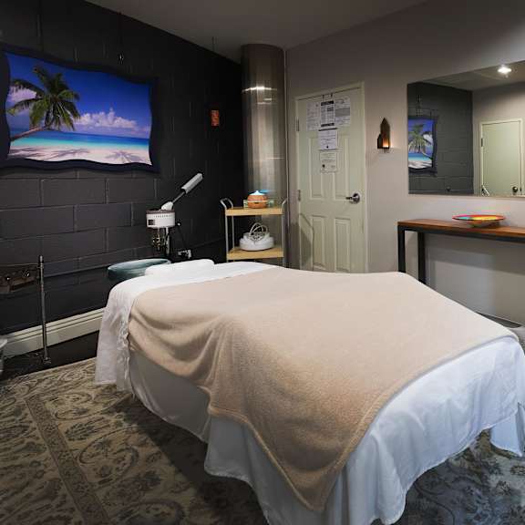 a room with a massage table and a chair. at la jolla crossroads apartments, california