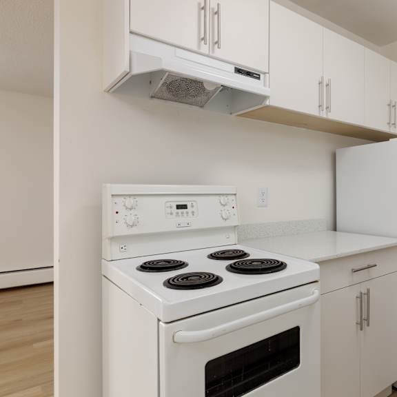 a white stove and refrigerator in a kitchen.