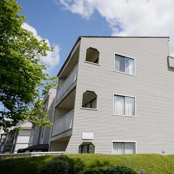 a modern building with a curved facade and multiple windows.