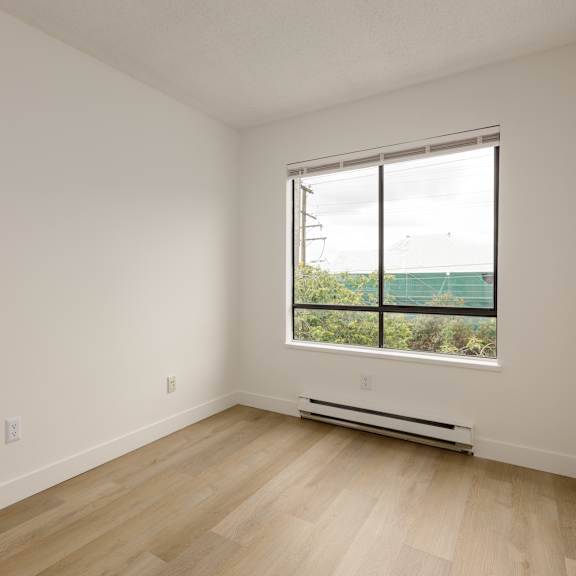 a room with a window and a radiator on the floor.