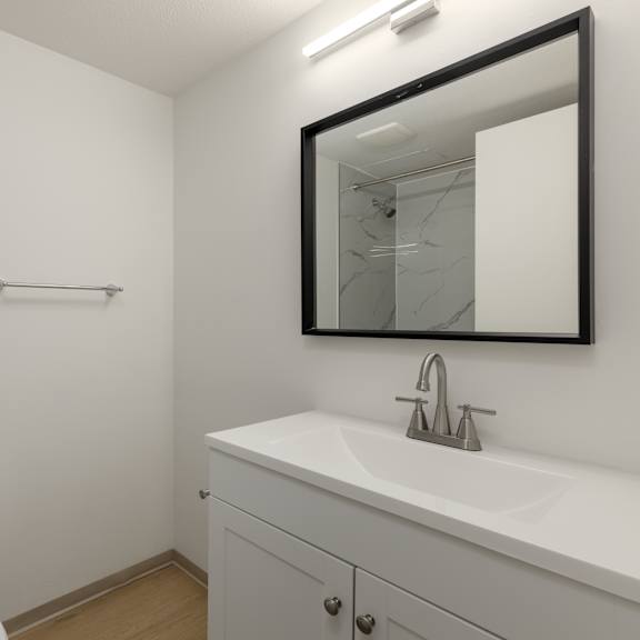 a white toilet sits next to a white sink in a small bathroom.