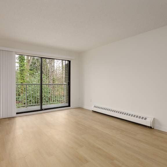 a room with a sliding glass door and a radiator on the floor.