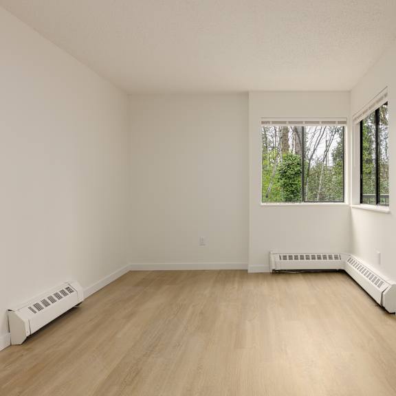 a room with a window and a white wall.