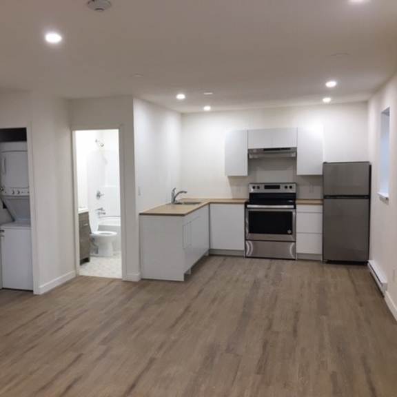 a kitchen with white cabinets and stainless steel appliances.