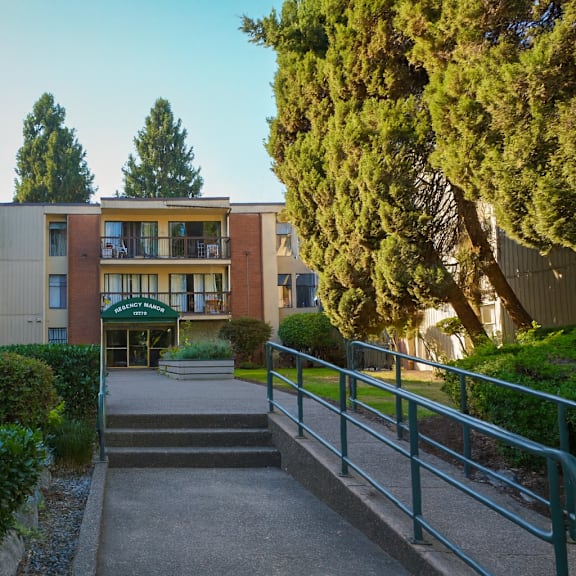 a building with a green lawn in front.