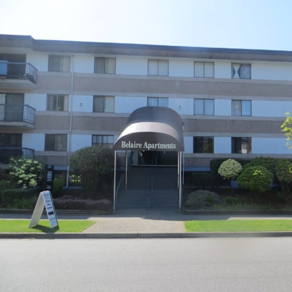 a building with the name "relaie apartments" on a sign in front of it.