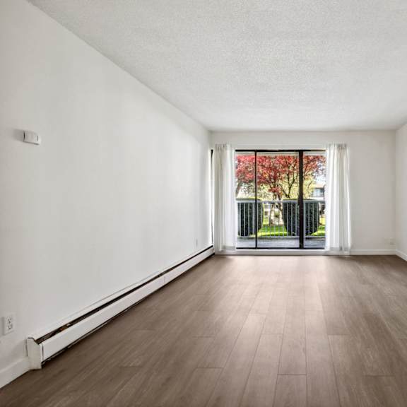 a room with wooden floors and white walls.