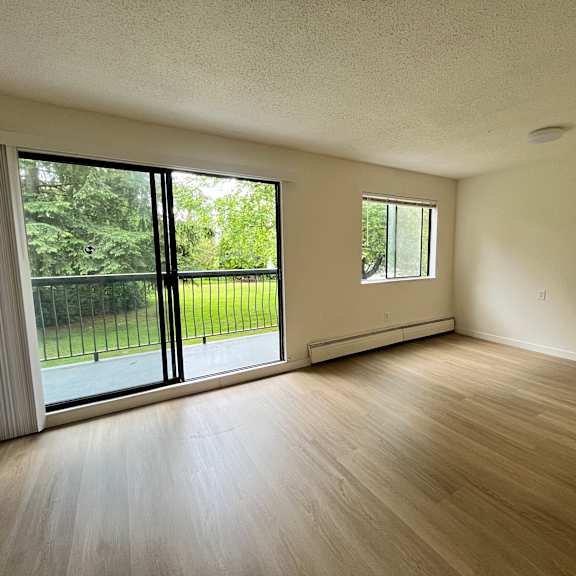 a room with a sliding glass door and a window.