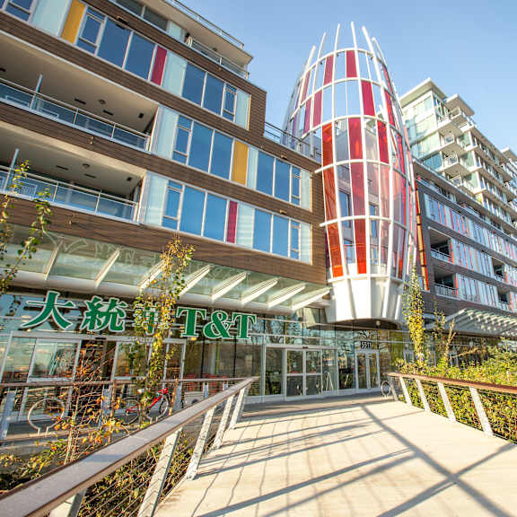 a modern building with a red and white tower in the center.