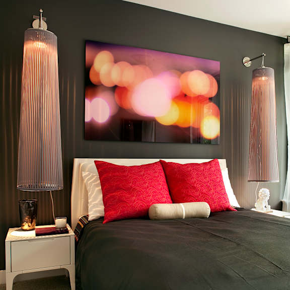 a bedroom with a large bed and a painting on the wall.