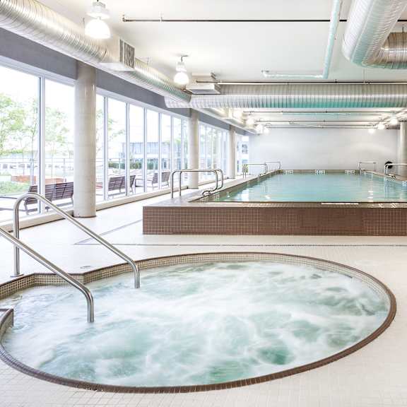 a large indoor swimming pool with a hot tub.