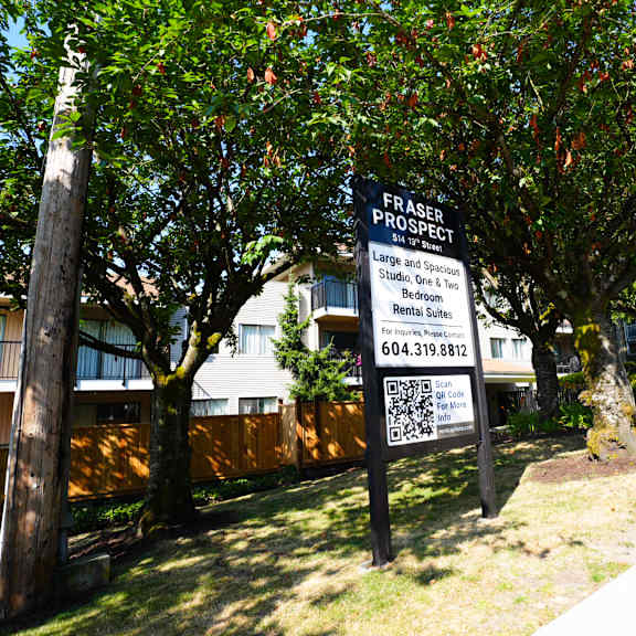a sign for fraser property is displayed in front of a building.