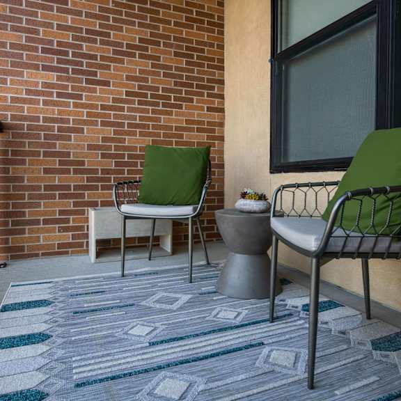 Thumbnail 8 of 8 Spacious Patio with 2 chairs, a table, and planters at The Apex at CityPlace at The Apex at CityPlace, Overland Park