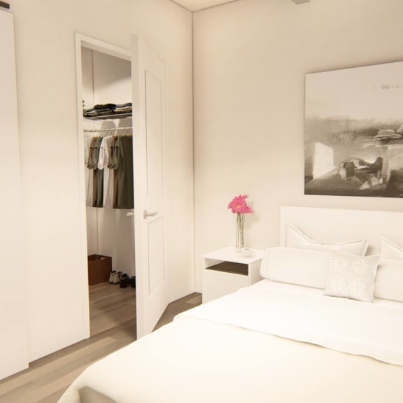Thumbnail 11 of 12 a bedroom with a large bed and a closet at Brownstones at Palisade Park Townhomes, Broomfield