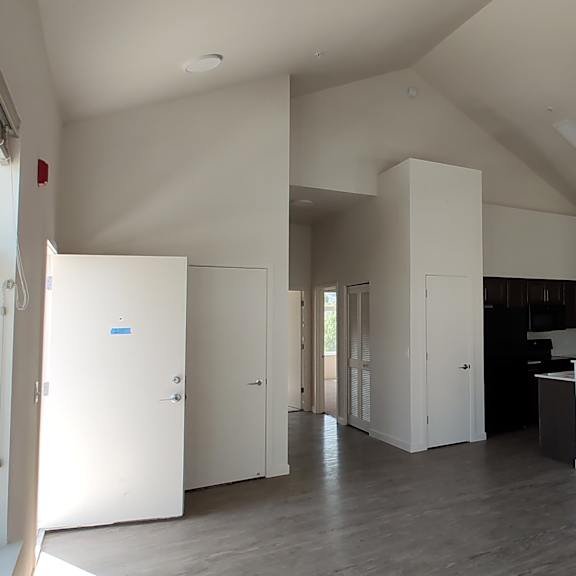 an empty room with white walls and a fireplace