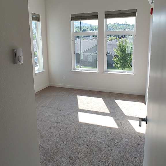 an empty room with three windows