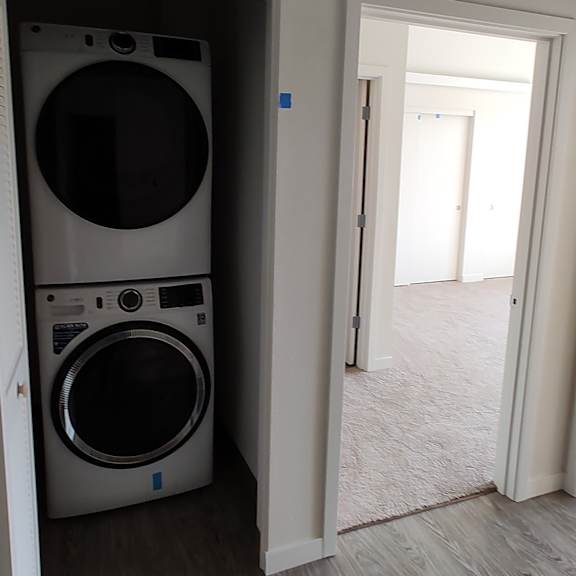 a front loading washer and dryer in a laundry room