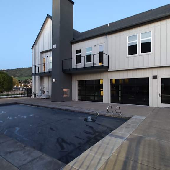 a new house with a swimming pool in front of it