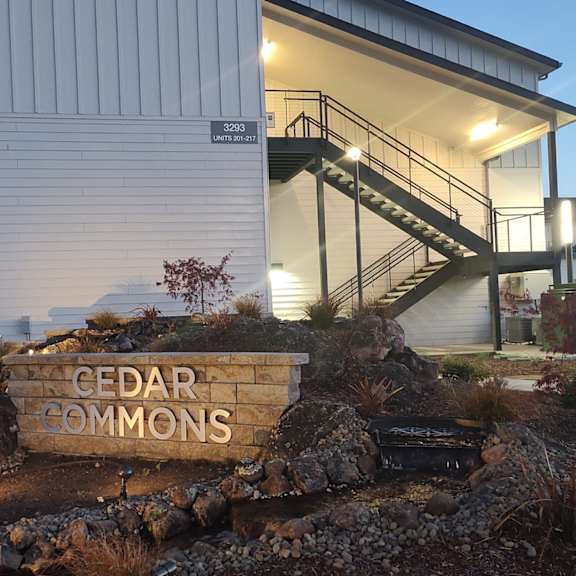a sign in front of a house that readscedar apartments