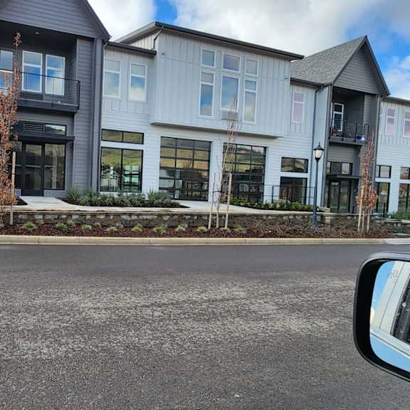a view of a building from the side of a street