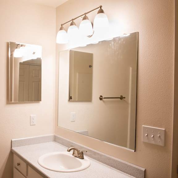 bathroom with vanity lights at wingsong manor apartments, portland, 97215