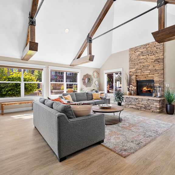 a living room with couches and chairs and a fireplace