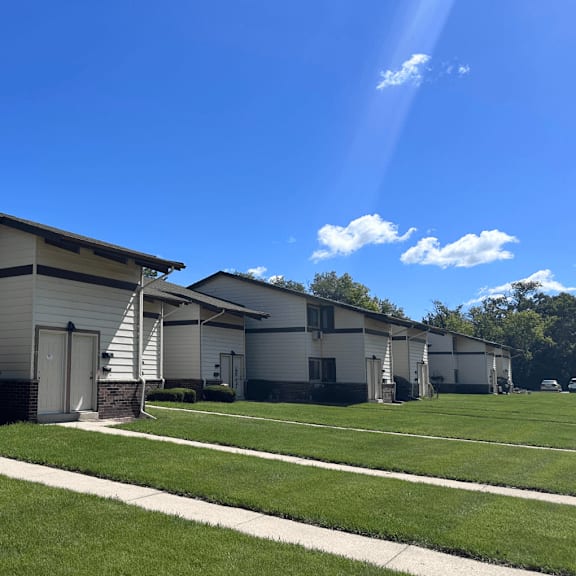 a row of houses with a clear blue sky above them.