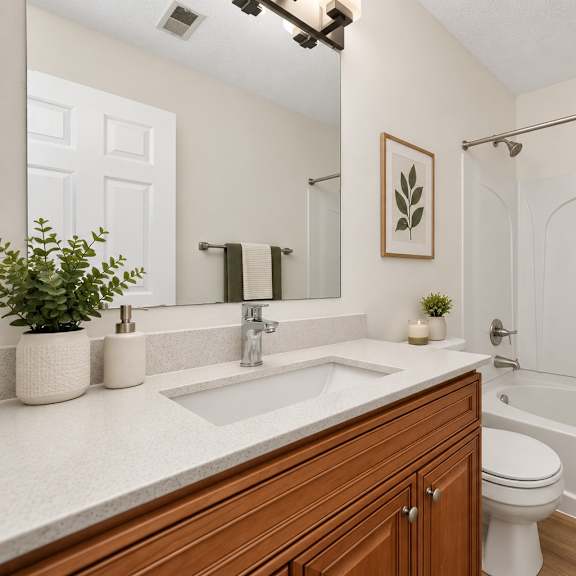 Thumbnail 5 of 8 A bathroom with a white tub, sink, and toilet.