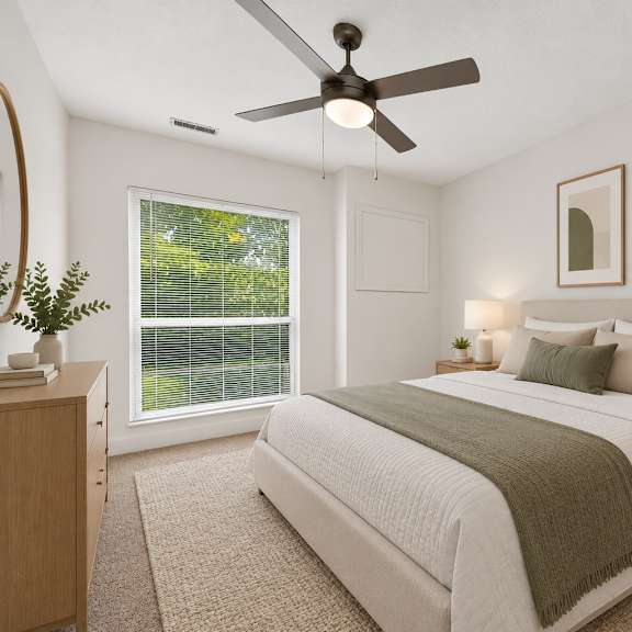 Thumbnail 3 of 8 A bedroom with a bed, nightstands, and a ceiling fan.