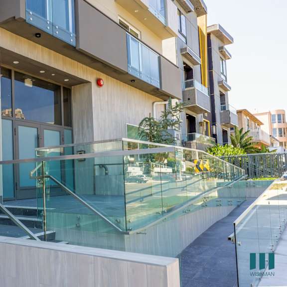a view of a building with a glass staircase in front of it