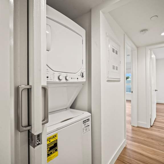 a white fridge with a yellow sticker on it.