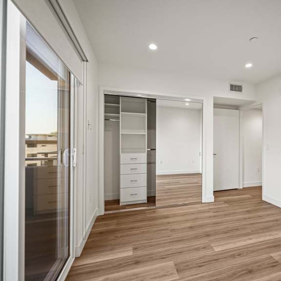 a room with a wooden floor and white walls.