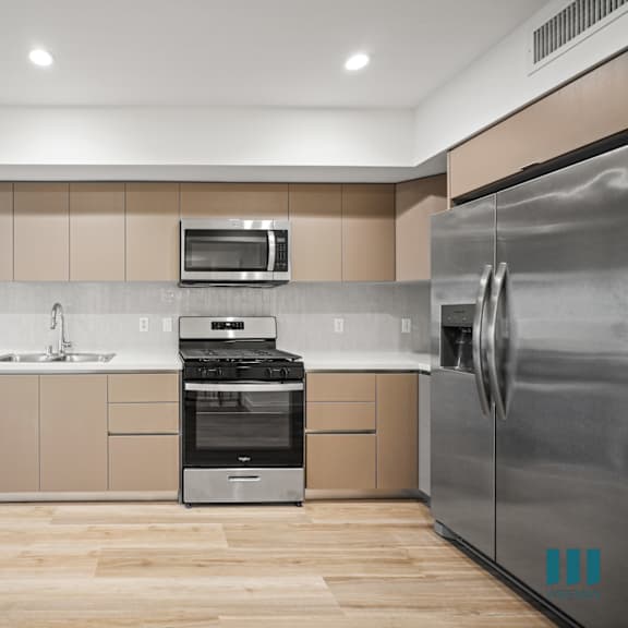 a modern kitchen with a stainless steel refrigerator.