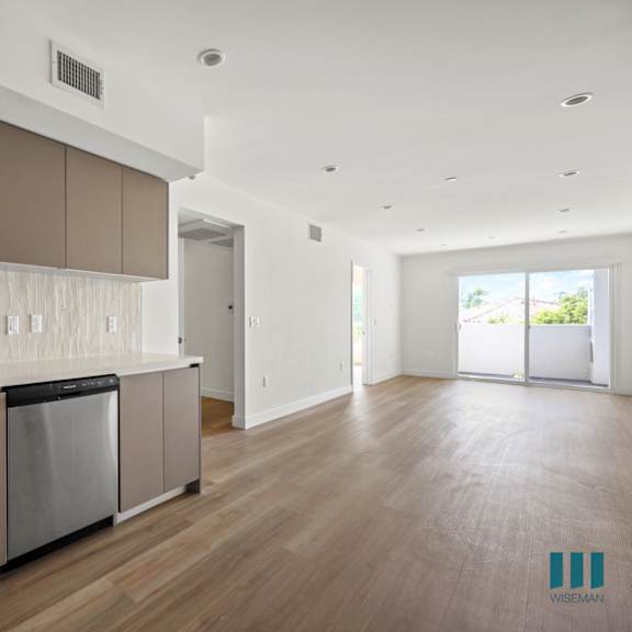 an empty kitchen with a sink and a dishwasher