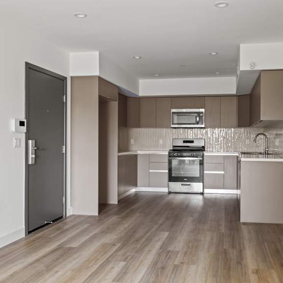 a view of a hallway with white walls and wood floors