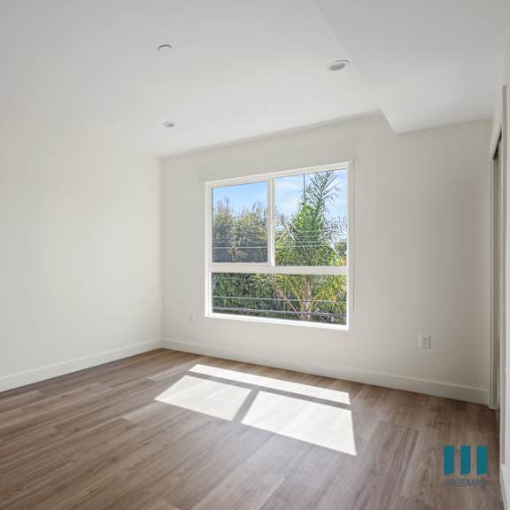 a room with large windows and a wooden floor