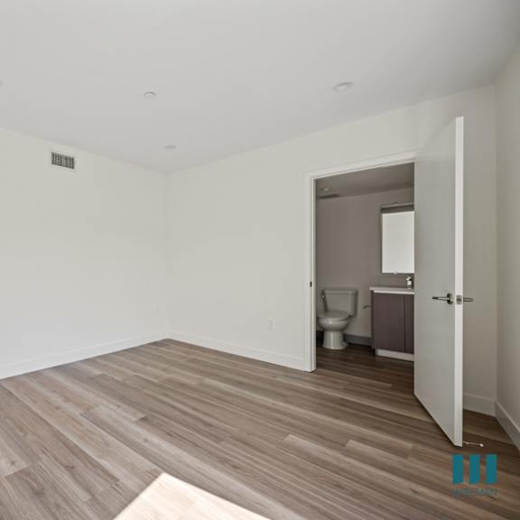 a view of a room with white walls and a wood floor