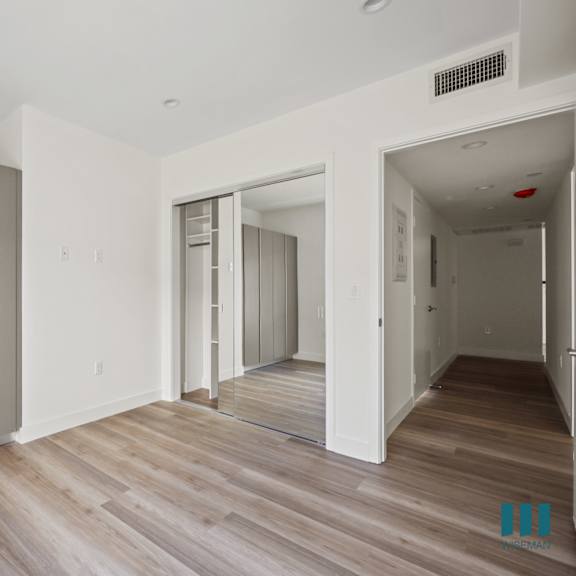 a renovated apartment with white walls and wood floors