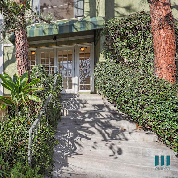 a house entrance with a green awning and a white door.