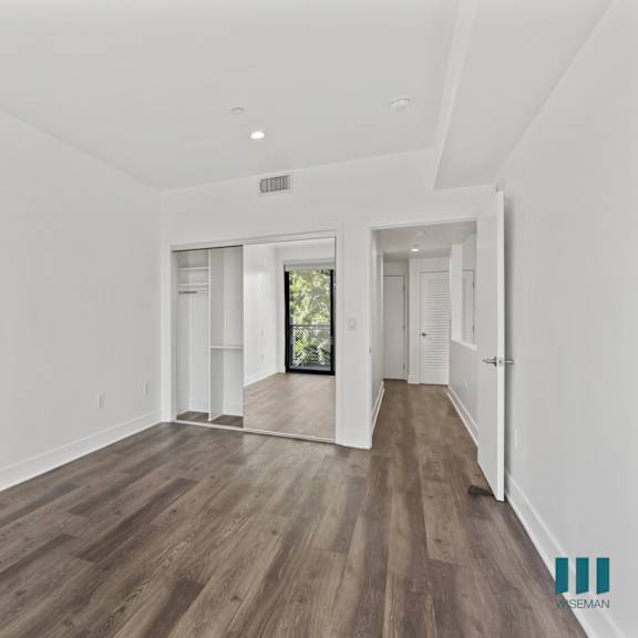 bedroom with mirrored closet, recessed lighting, and vinyl flooring