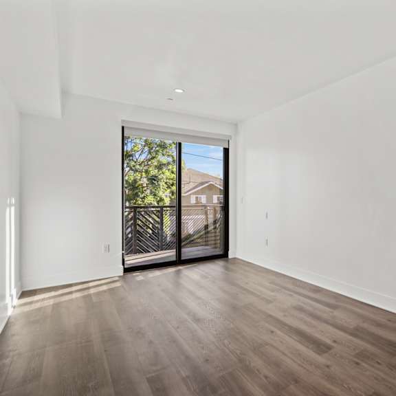 living room with vinyl flooring and balcony