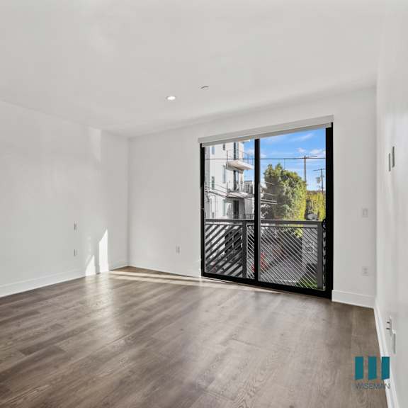 living room with recessed lighting, vinyl flooring, and balcony