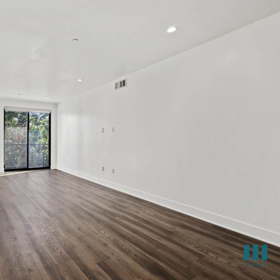 living room with vinyl flooring, recessed lighting, and balcony