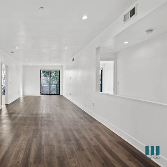 open-concept living and dining room space with patio