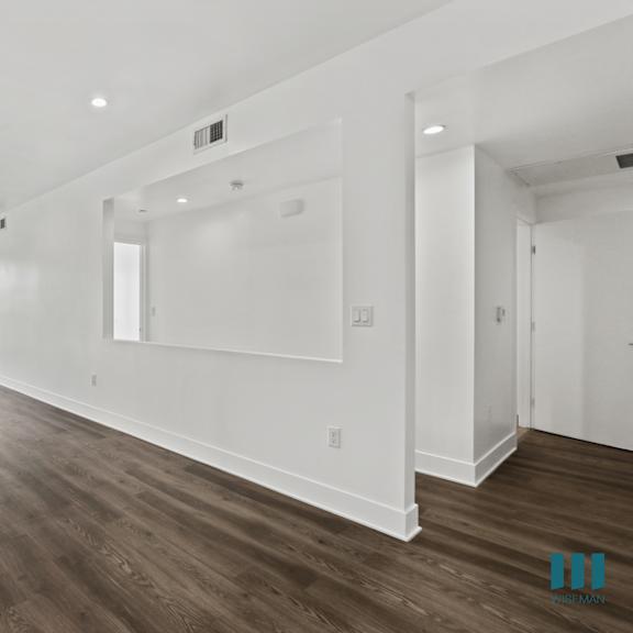 open-concept dining and living room space with balcony, vinyl flooring, and recessed lighting